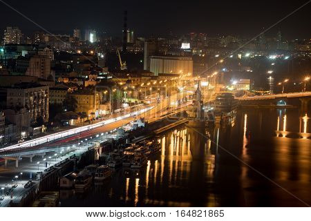 Bustle of the city, the road and the car on the bridge at night by the light