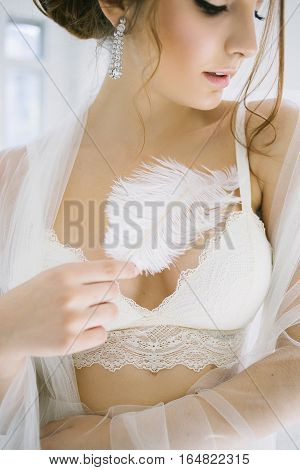 woman face portreit with feathers. bride morning