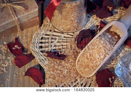 Composition of spa treatment. Natural handmade soap and sea salt with fragrant herbs. Spa concept.
