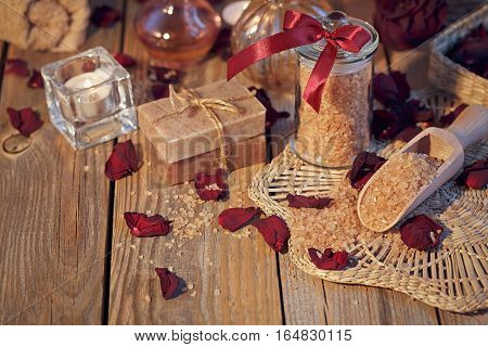 Composition of spa treatment. Natural handmade soap and sea salt with fragrant herbs. Spa concept.