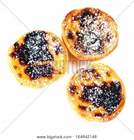 Typical portuguese dessert pasteis de nata / Heap of egg tarts isolated on white background close up