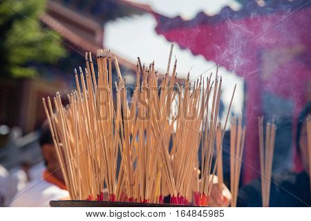 Burning Incense sticks in plublic Temple Thailand
