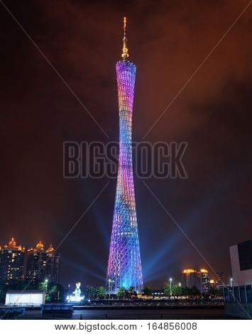 GUANGZHOU GUANGDONG PROVINCE CHINA - NOVEMBER 7 2015: Night view of the Canton Tower (Guangzhou TV Astronomical and Sightseeing Tower). Beautiful colorful tower glows and emits blue light rays.