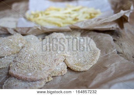 preparing breaded veal cutlet with french fries
