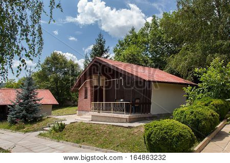 Wooden bungalows and garden in the forest. Holiday apartmens