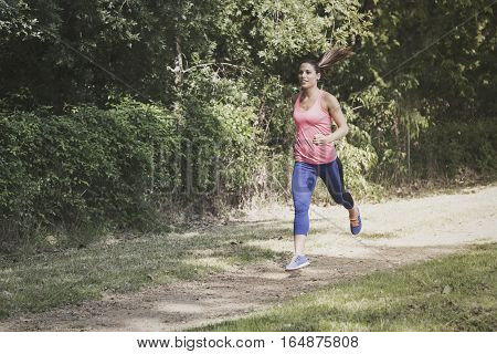Beautiful woman doing stretching exercices in the park
