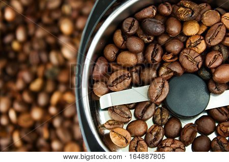 The coffee beans in an electric grinder.