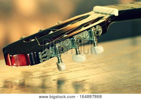 Detail of Burgundy wooden guitars. Detail of the Spanish guitar. Picture of the music string instrument.