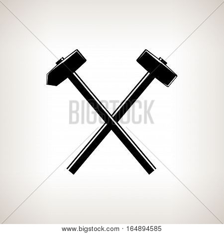 Silhouette of a crossed hammer and sledgehammer on  light background, black and white illustration