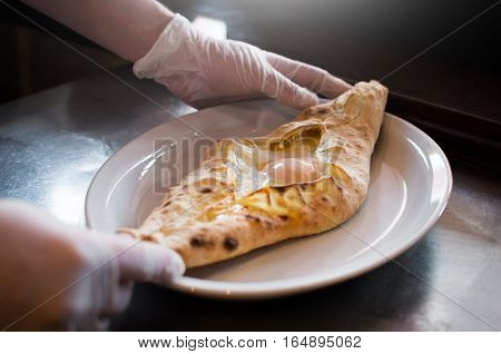 A man puts a Georgian bakery window