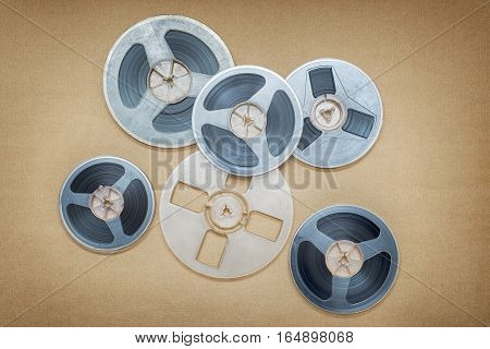 Vintage magnetic audio reels on the brown paper background