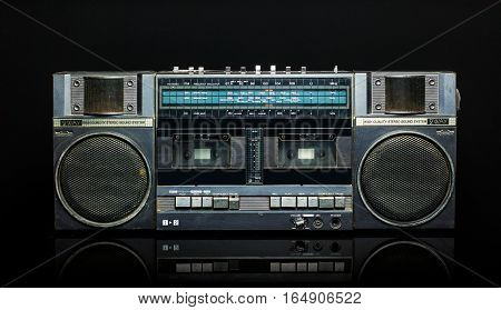 Vintage boom box on black background. Radio cassette