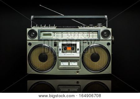 Vintage boom box on black background. Radio cassette