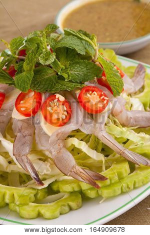 A Thai style dish of raw sea prawn served with cabbage and bitter cucumber and mint in spicy sauce.