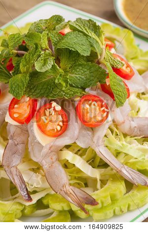 A Thai style dish of raw sea prawn served with cabbage and bitter cucumber and mint in spicy sauce.