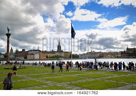 STOCKHOLM SWEDEN - AUGUST 19 2016: Tourists walk and visit Stockholm City Hall ( Stadshuset ) and View of Gamla Stan in Stockholm Sweden on August 19 2016.