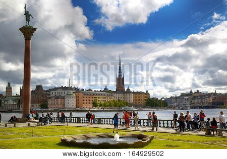 STOCKHOLM SWEDEN - AUGUST 19 2016: Tourists walk and visit Stockholm City Hall ( Stadshuset ) and View of Gamla Stan in Stockholm Sweden on August 19 2016.