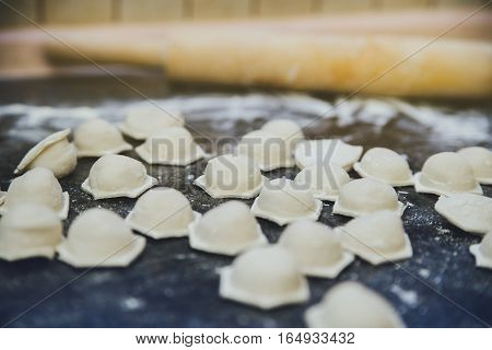 raw dumplings on the kitchen table with flour