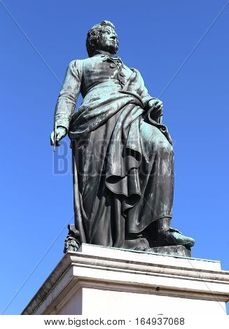 Big Statue Of The Composer Mozart With The Background Of The Blu