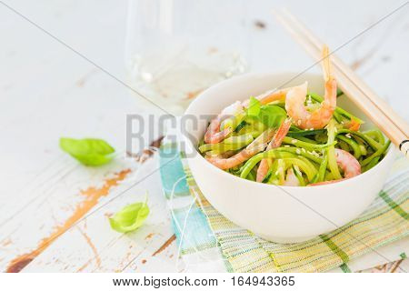 Zucchini pasta in white bowl, copy space