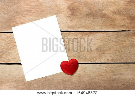 A sheet of paper with a heart not a wooden background