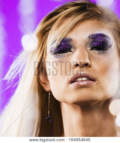 beauty young snow queen lady in fairy flashes with hair crown on her head close up in cold blue light