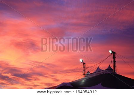 Circus tent under the colourful sunset sky