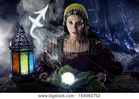 Psychic or fortune teller with crystal ball and horoscope zodiac sign of Sagitarius