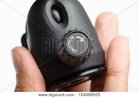 Closeup friction control knob on ball head of tripod