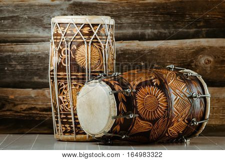 variation of beautiful ethnic indian drums dholak on wooden background