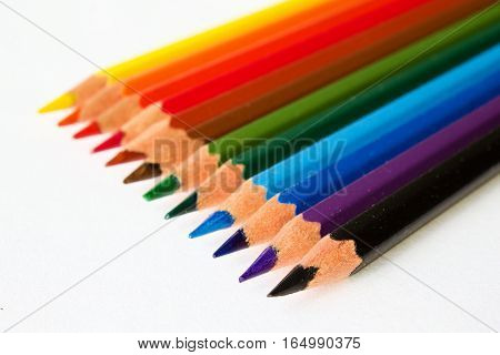 Crayons lined up on a white background.
