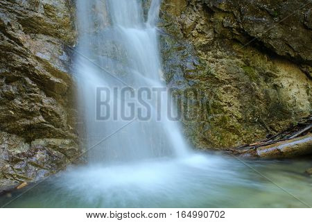 On the image is small watterfall in nature.