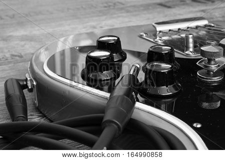 Black and white photos of the electric guitar into the amplifier.