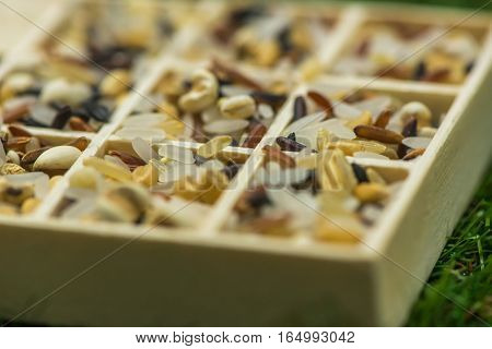 Variety of healthy grains and seeds in a wooden box mostly gluten free with rice, Sensitive Focus