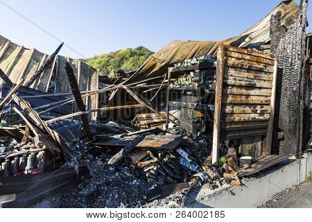 Damaged Industry Supermarket Metallic Facade After Arson Fire With Burnt Debris After Intense Burnin