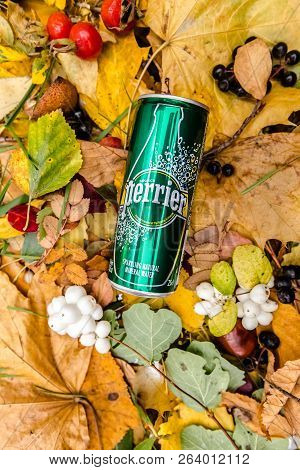 Saint-petersburg, Russia, 17102018 Perrier In A Glass Tin Bottle On Autumn Yellow Green Foliage Of T