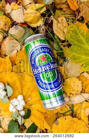 Saint-petersburg, Russia, 17102018 Beer Heineken In A Glass Bottle On Autumn Yellow Green Foliage Of