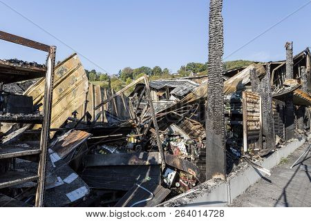 Damaged Industry Supermarket Metallic Facade After Arson Fire With Burnt Debris After Intense Burnin