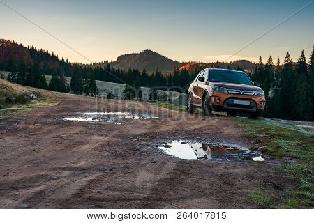 Apuseni, Romania - Oct 15, 2017: Orange Suzuki Vitara Suv Parked On The Country Road Near Forest In 