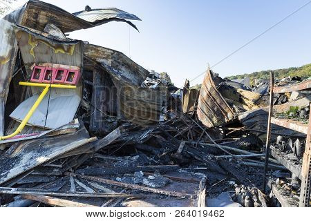 Damaged Industry Supermarket After Arson Fire With Burn Debris Of Twisted Metal Wood Structure After