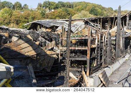Damaged Industry Supermarket After Arson Fire With Burn Debris Of Twisted Metal Wood Structure After