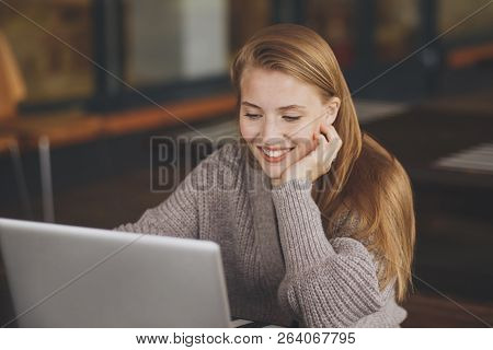 Successful Female Grapic Designer Watching Tutorial About Creative Ideas At Laptop Computer During W