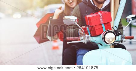 Portrait of happy couple with shopping bags after shopping in city