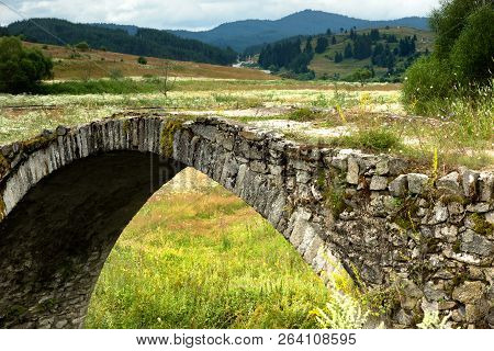 Old Roman Bridge In The Rodopi Mountain Located In Bulgaria