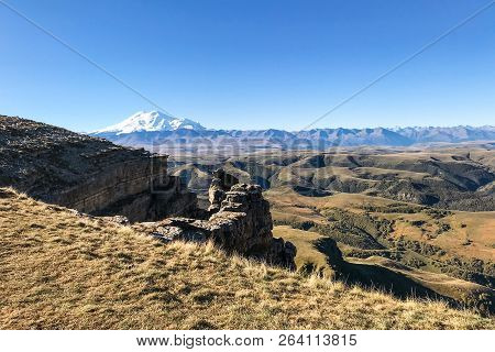 Travel To North Caucasus Region Region - Cliff Of Bermamyt Plateau And View Of Mount Elbrus At Morni