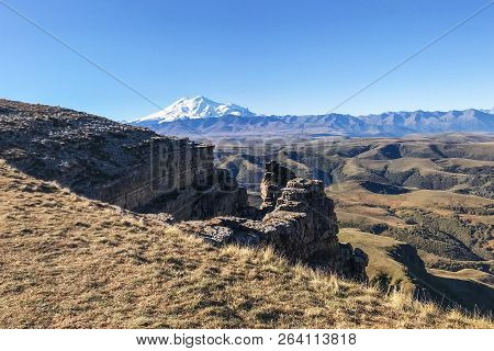 Travel To North Caucasus Region Region - Old Rocks Of Bermamyt Plateau And View Of Mount Elbrus At M