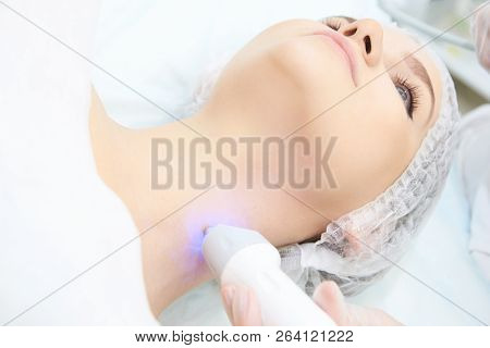 Facial Micro Current Cosmetology Procedure. Beauty Technology Treatment. Woman Face Therapy