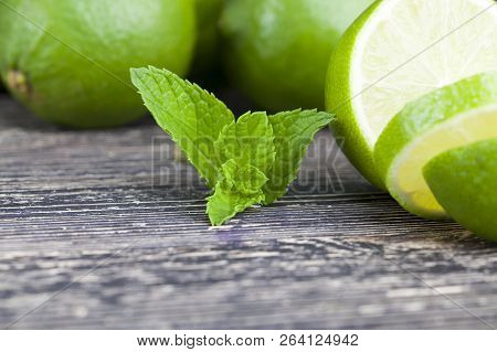 Sliced Green Lime With A Mint Leaf During Cooking