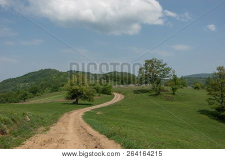 Landscape With Hills, Meadows And Dirt Road On Radan Mountain Massif, Near Rock Formation Djavolja V