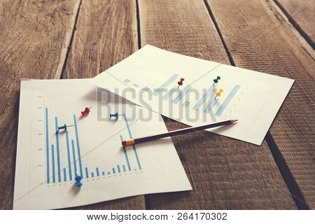 Workplace On Wooden Table With Graph Papers